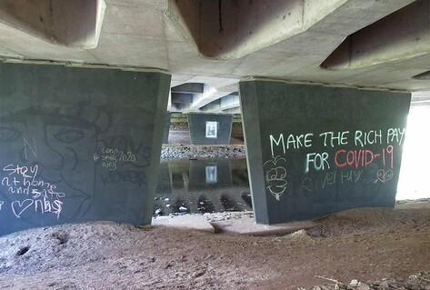 Graffiti under bridge on concrete wall